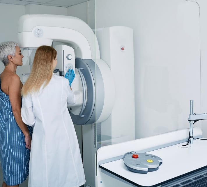 Procedimiento de mamografía en clínica médica, mamografía. La mamóloga coloca a una mujer madura en una máquina de imágenes para recibir una mamografía